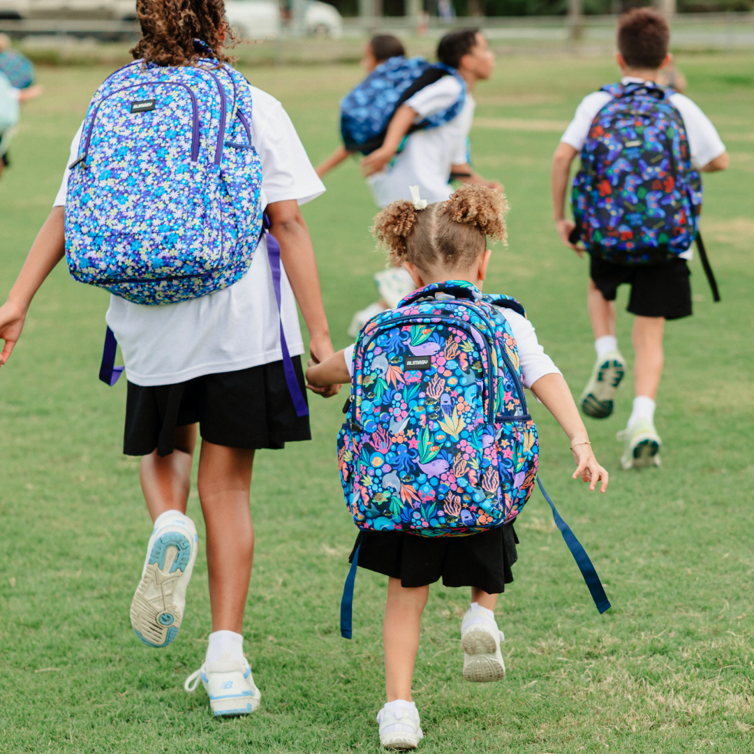 Sealife Midsize Kids Backpack lifestyle image child wearing and running in the grass a lightweight waterproof school bag for boys and girls