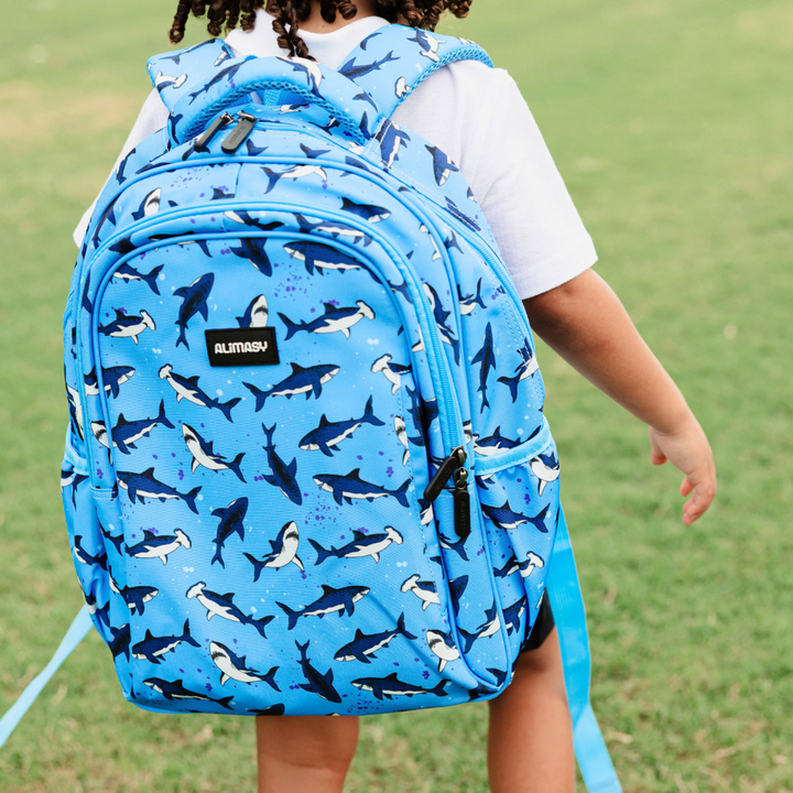 Sharks Midsize Kids Backpack lifestyle image child wearing, lightweight waterproof blue shark school bag for boys and girls