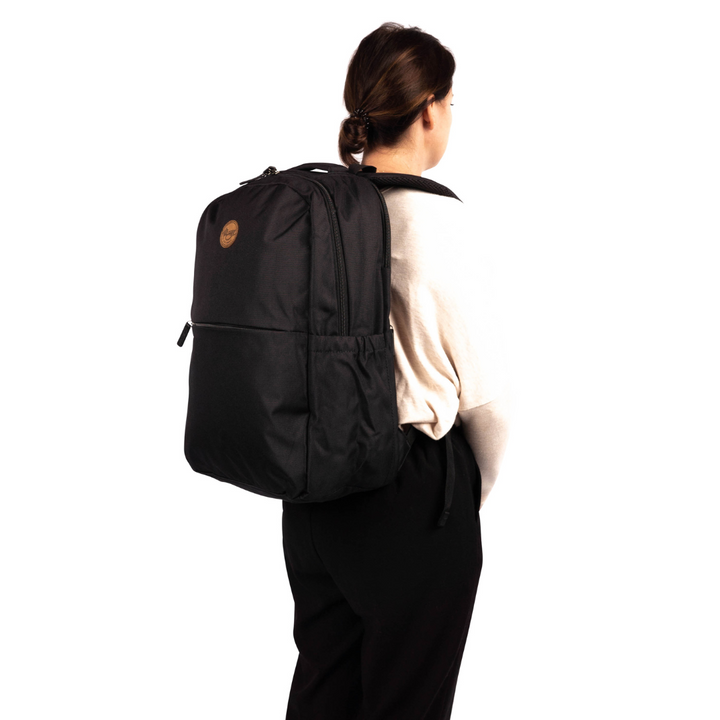 side view of female model wearing alimasy black laptop backpack