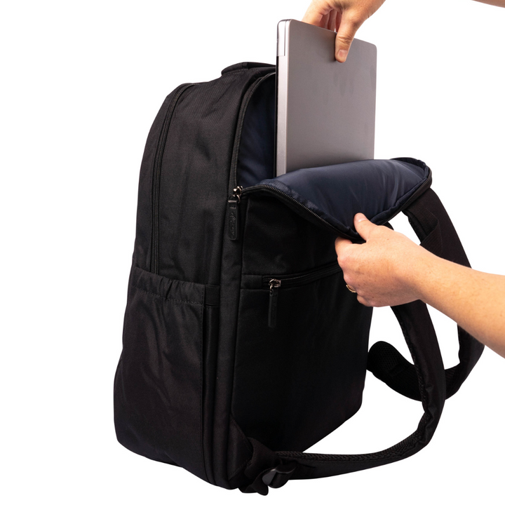 hand placing laptop into back pocket of alimasy black laptop backpack for work bag