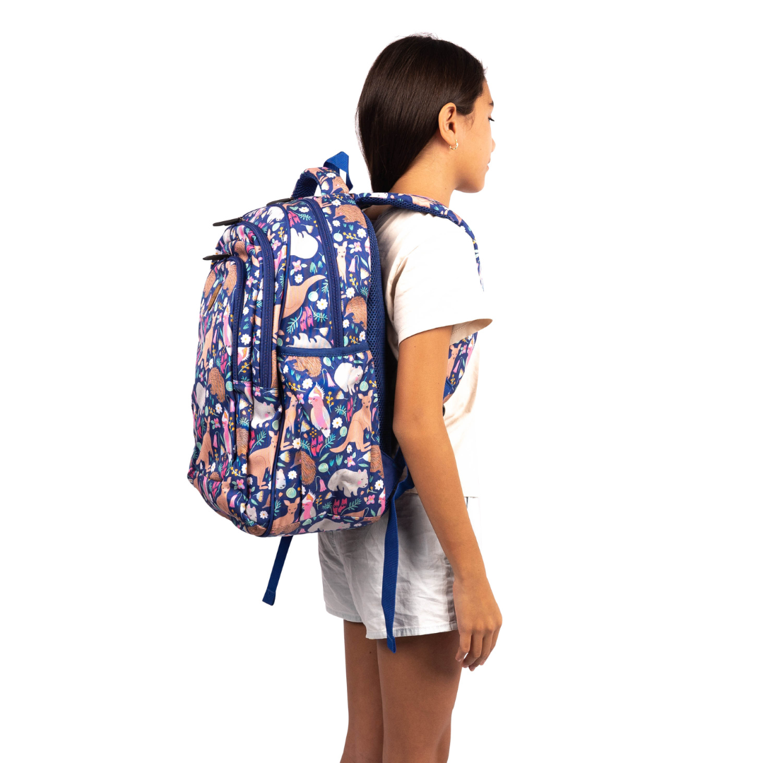 side view of girl wearing alimasy australian animal pattern backpack with blue background