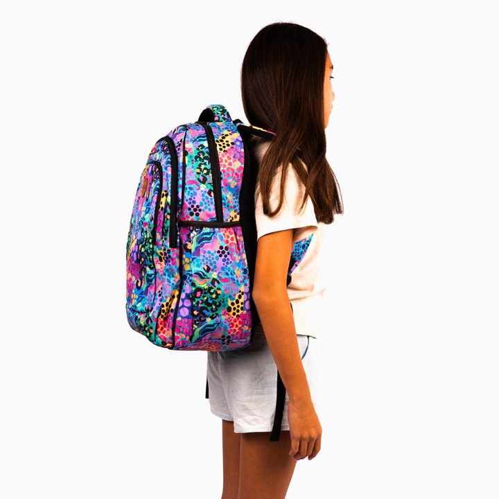 side view of girl wearing alimasy electric leopard large backpack for australian kids school bag